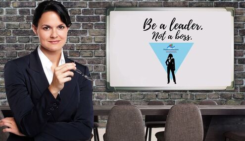 Photo of a lady standing in front of a sign that says Be a leader Not a boss. There is also a logo from https://www.market-connections.net
