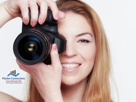 Photo of a smiling lady photographer. There is also a logo from https://www.market-connections.net