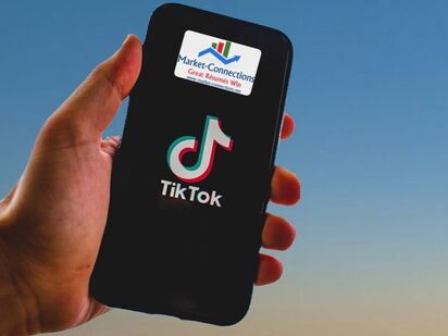 Picture of a cell phone with a logo from https://www.market-connections.net and a logo from Tik Tok