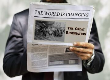 Person holding a newspaper with front cover about The Great Resignation. Use for a blog post by https://www.market-connections.net